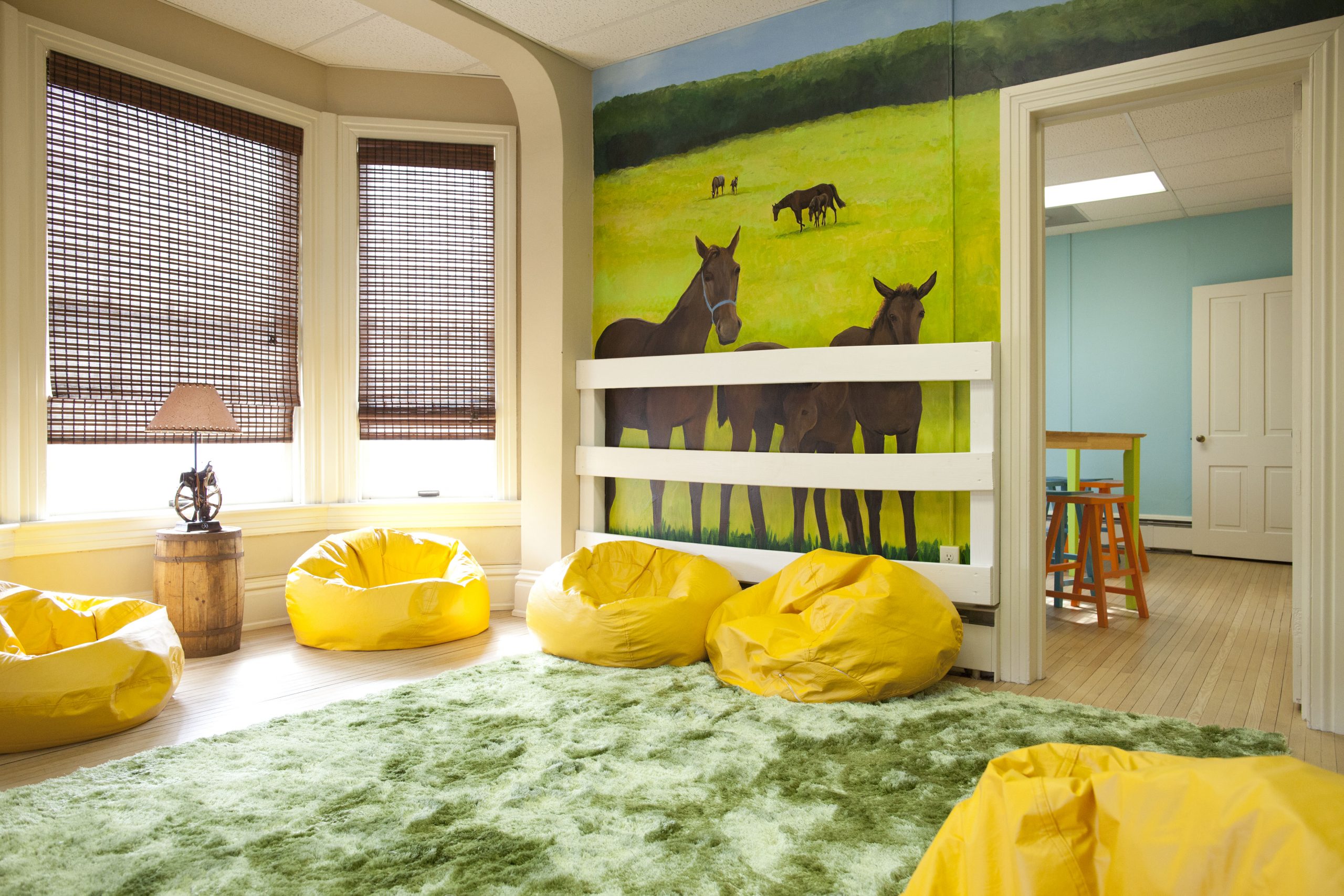 The Middle School Room The farm mural painted by Charlotte Yealy, depicts the role horses play at Olivia’s House in creating a sense of safety and security after trauma! Our equine therapy work has shown great results with the many children who have participated. Our dear friend and former Vice President, Wendell LaPrairie's family gifted this room to Olivia's House in his memory. He will live on in the laughter that fills this room on program nights!
