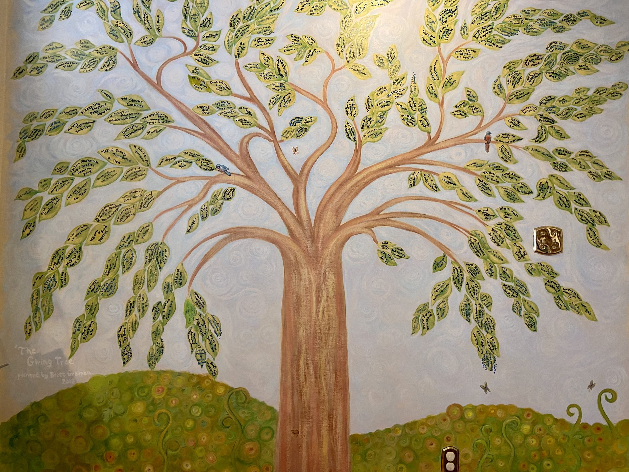 Located in the lending library and painted by artist Bret Greiman, the Olivia's House Giving Tree demonstrates how generous our community has been to the mission of Olivia's House. Any individual or organization that makes a gift of $1,000 or more gets to select a leaf to have their name permanently displayed.